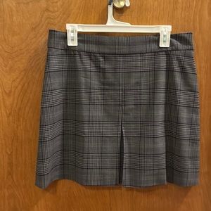 silver/grey and black mini skirt, zip back, pleat in front. above the knee.